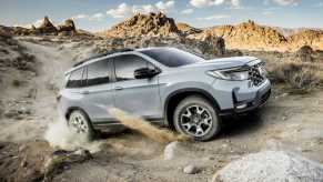 Gray 2022 Honda Passport TrailSport driving on mountainous terrain