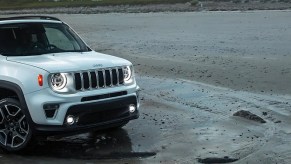 A white 2021 Jeep Renegade parked on the beach.