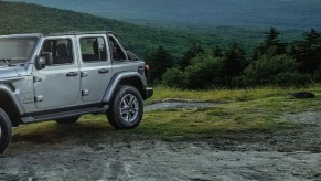 A gray 2021 Jeep Wrangler driving through the mountains.