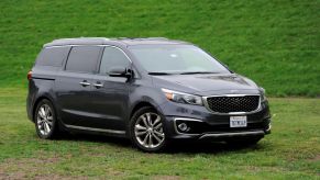 The 2016 Kia Sedona SXL minivan parked on a field of grass