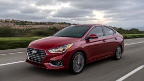 A red 2022 Hyundai Accent on the road on an overcast day