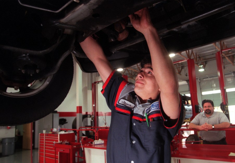 Mechanic Performing Maintenance On Car