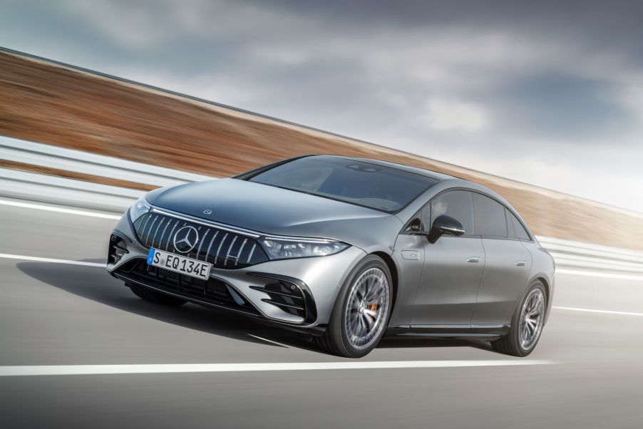 A metallic-gray Mercedes-AMG EQS 43 4Matic+ drives down a road