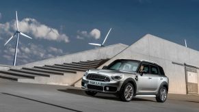 The Mini Cooper SE Countryman PHEV model parked near windmills