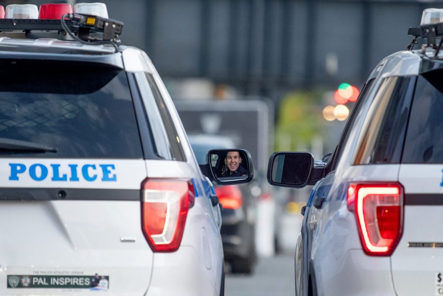 Two police vehicles parked side by side in a city