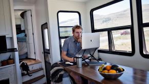 Programmer Kevin Holesh working on his computer using his RV internet