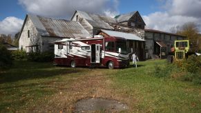 A recovery repo agent retrieving an RV parked on a farm