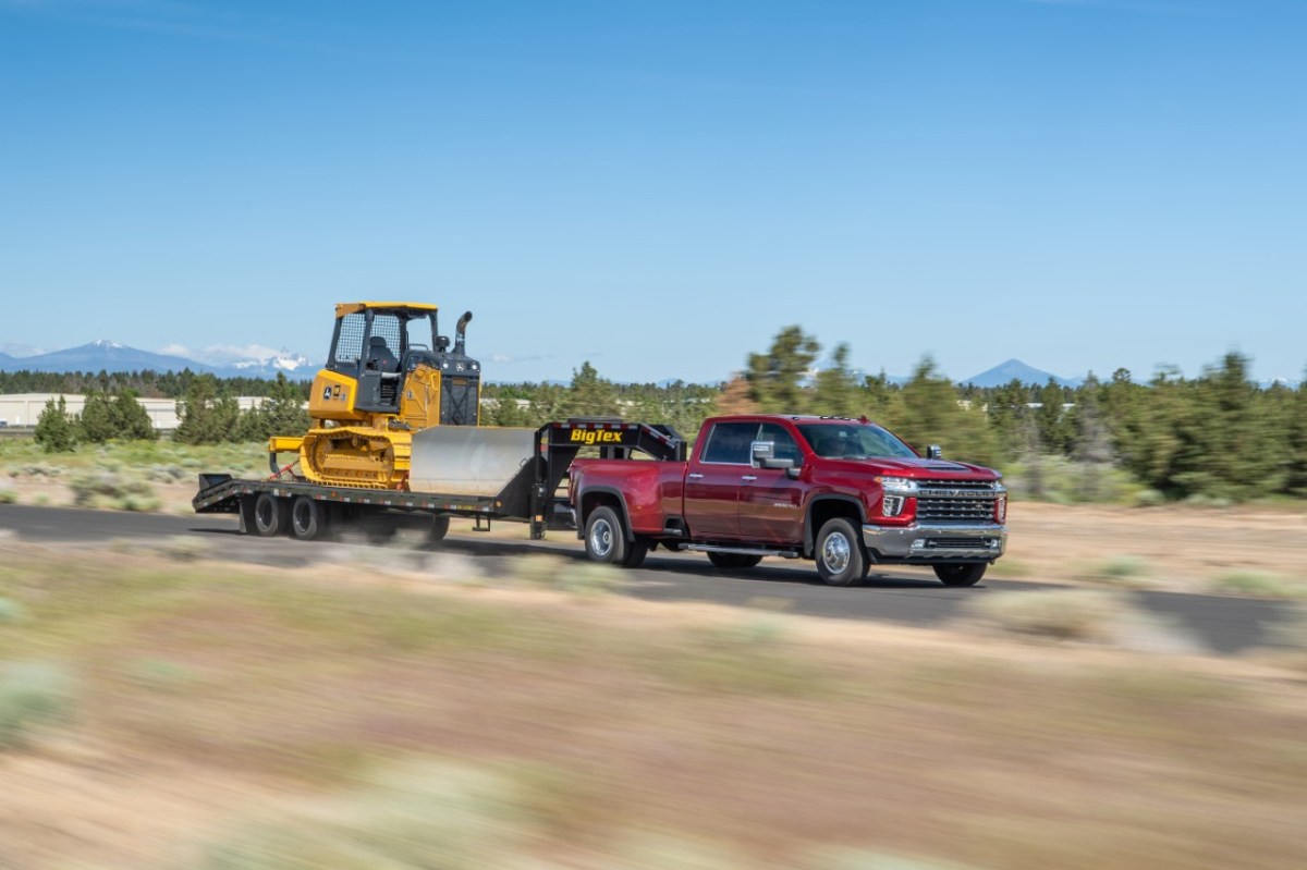 Red 2021 Chevrolet Silverado 3500HD towing a trailer