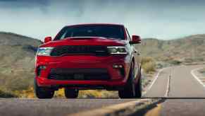 Red 2021 Dodge Durango driving on a desert highway