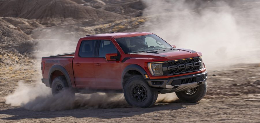 Red 2021 Ford F-150 Raptor driving on mountainous terrain