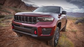 Red 2022 Jeep Grand Cherokee parked on a muddy trail