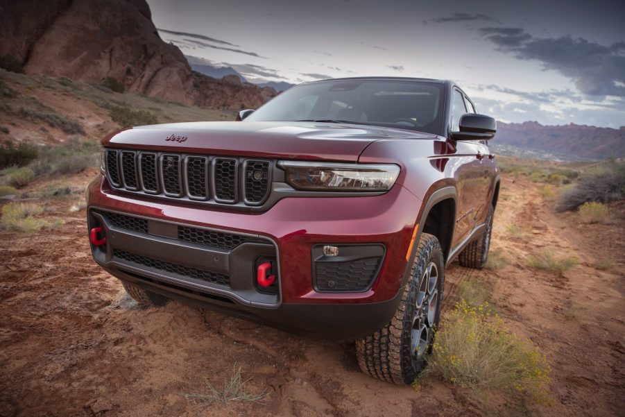 Red 2022 Jeep Grand Cherokee parked on a muddy trail