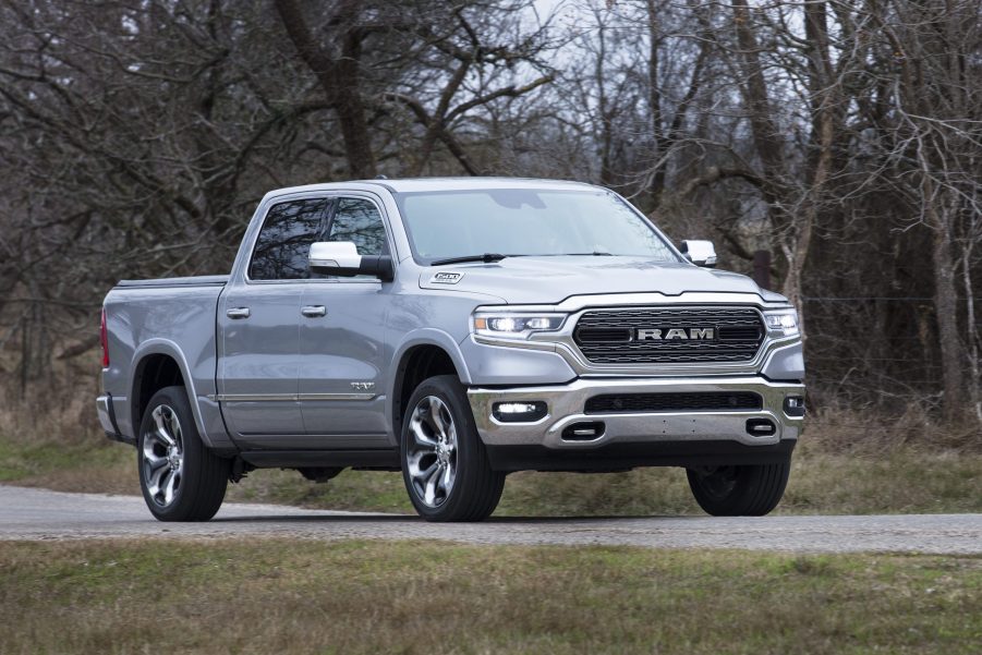 Silver 2022 Ram 1500 driving by a forest