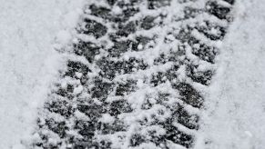 A snow tire print in the snow.