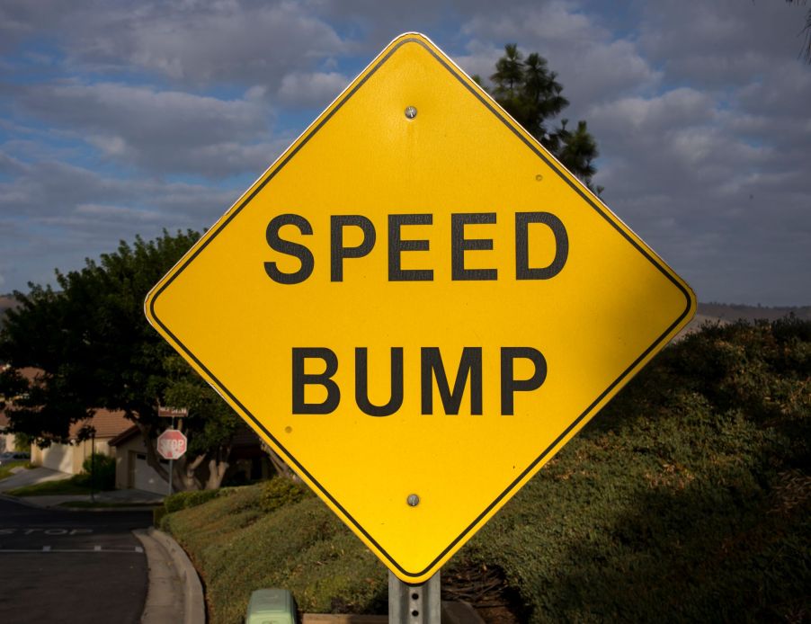 Yellow Speed Bump sign along a highway.