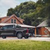 The 2022 Toyota Tundra's towing capacity is 12,000 pounds. This is a promo photo of a gray truck towing a boat.