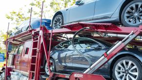 A Tesla delivery truck filled with Tesla Model 3 vehicles