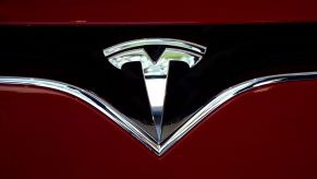 Tesla logo on a red car.