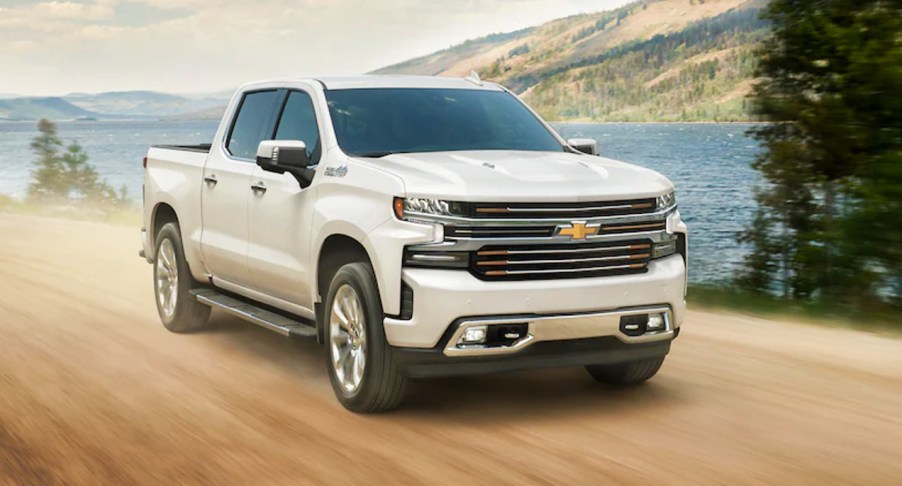 A white 2021 Chevy Silverado on a dirt road.