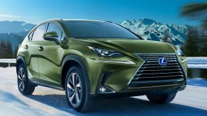 A green Lexus NX450h parked outside