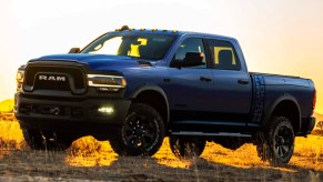 A Ram 2500 Power Wagon parked in a field during a sunset