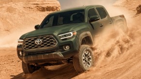 Green 2021 toyota tacoma driving in the desert