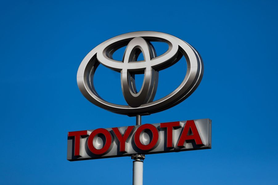 Toyota Sign with the logo on top and Toyota written in red.