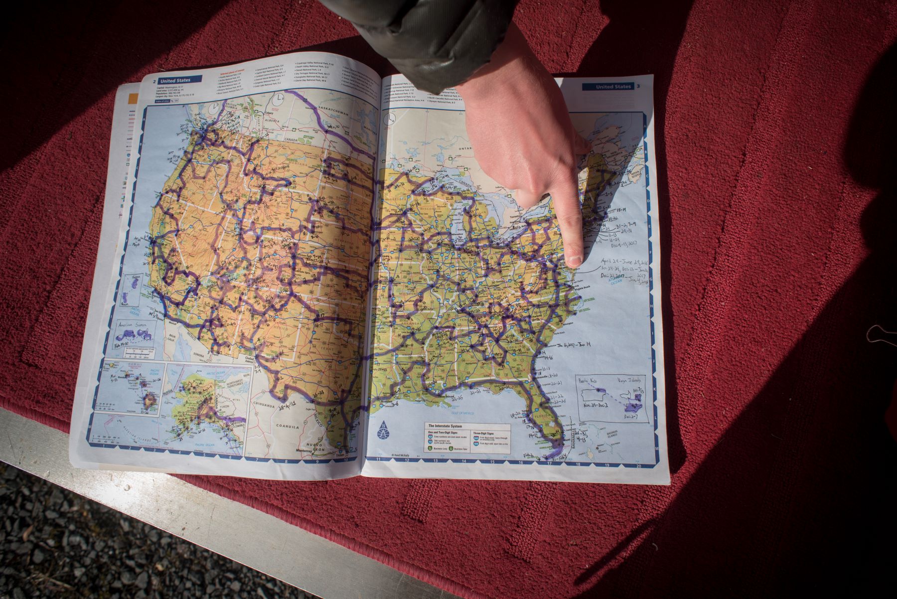 Someone pointing to a location on a map of the United States