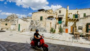 A man driving a Vespa scooter in Basilicata, Italy