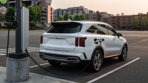 White 2022 Kia Sorento Plug-In Hybrid charging at a charging station