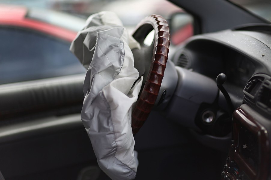 A deployed air bag sagging in front of a steering wheel. Similar to the kind seen in the airbag recall