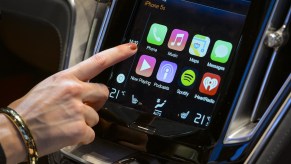 A visitor presses the new Apple's CarPlay touch-screen