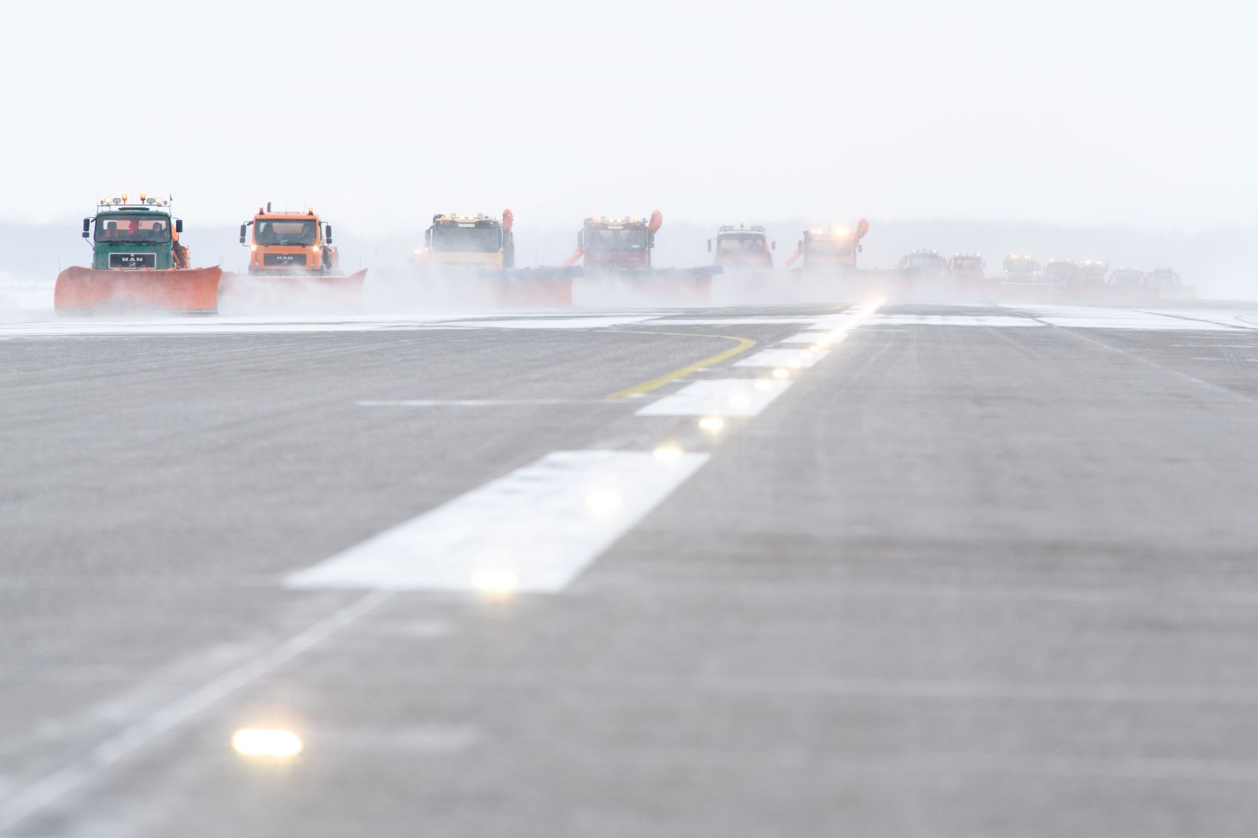 The Munich Airport covered in black ice as snow ploughs clear the runway