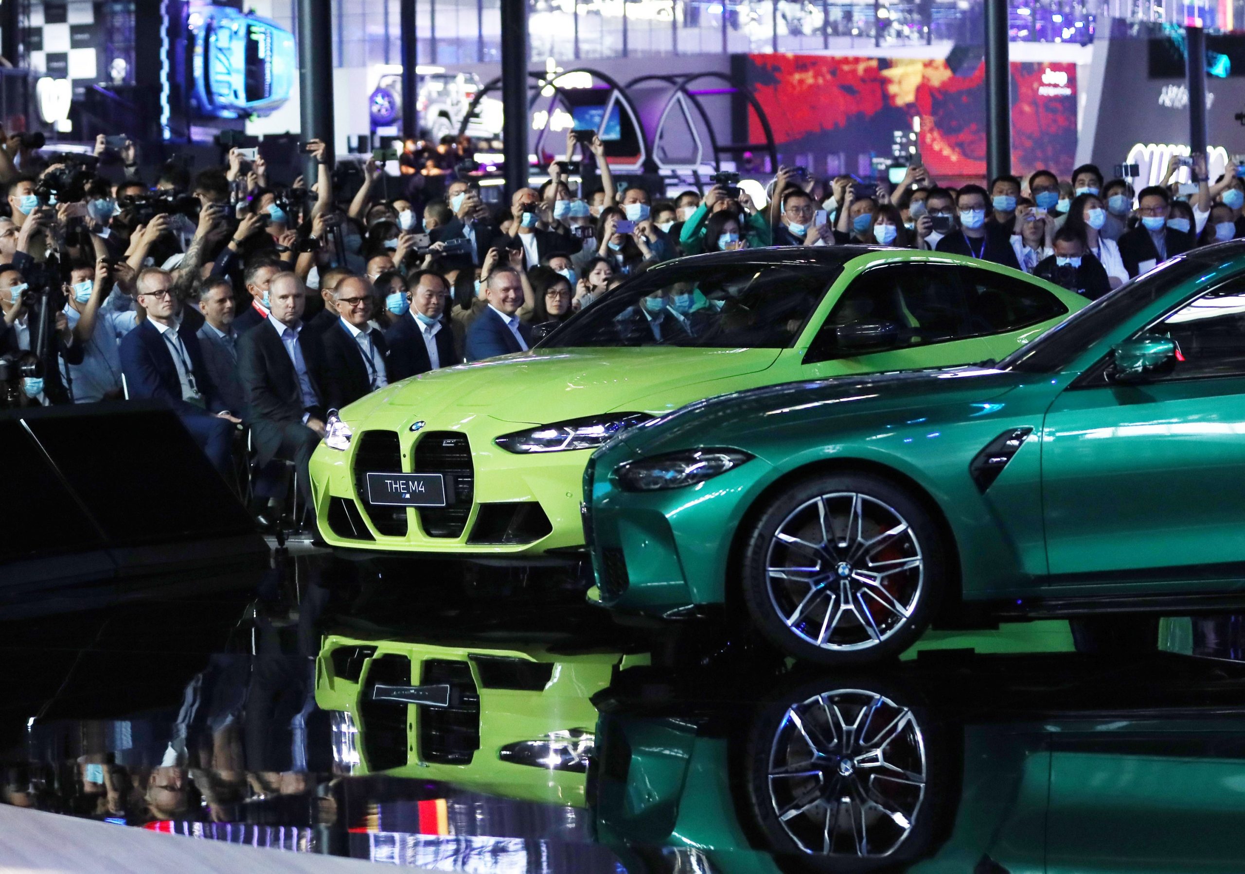 A pair of BMW M3 and M4 sports cars sporting the iconic BMW kidney grille at their debut in China, shot from the front 1/4 angle