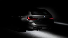 The silhouette of the 2022 BMW M3 touring shot from the rear 3/4 angle