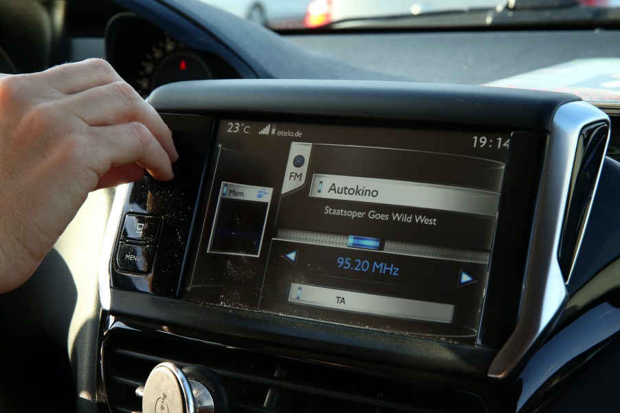 A visitor in a car tunes her radio to the drive-in live broadcast of the Staatsoper Unter den Linden