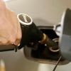 A driver filling up a car at a diesel fuel station