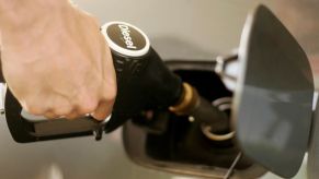 A driver filling up a car at a diesel fuel station