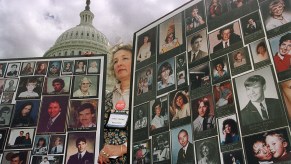 Mothers Against Drunk Driving volunteer Janet Priewe of Wisconsin holds up picture posters of drunk driving victims