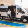 a woman using the lift in the new wheelchair accessible Winnebago Roam