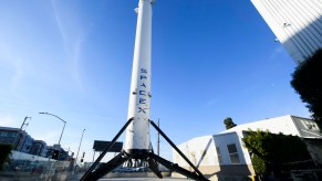 The recovered first stage of a Falcon 9 rocket stands at Space