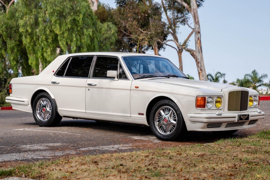 A white 1990 Bentley Turbo R with yellow headlights in a parking lot