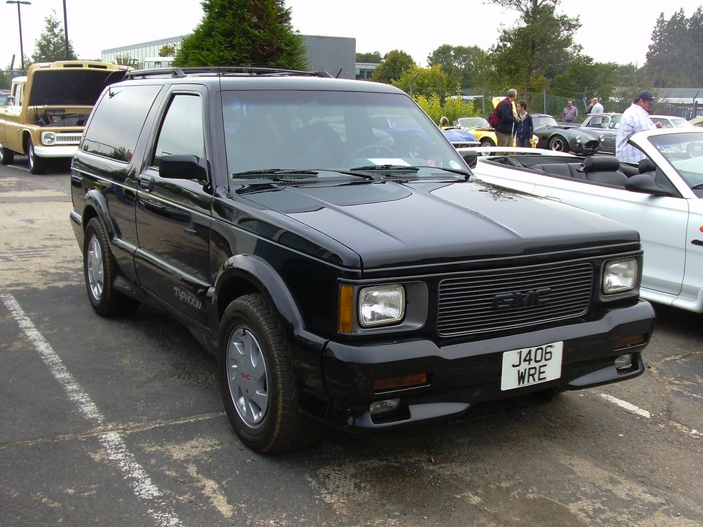 A black 1992 GMC Typhoon parked outside in a parking lot