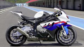 The side view of a white-blue-and-red 2010 BMW S 1000 RR on a racetrack