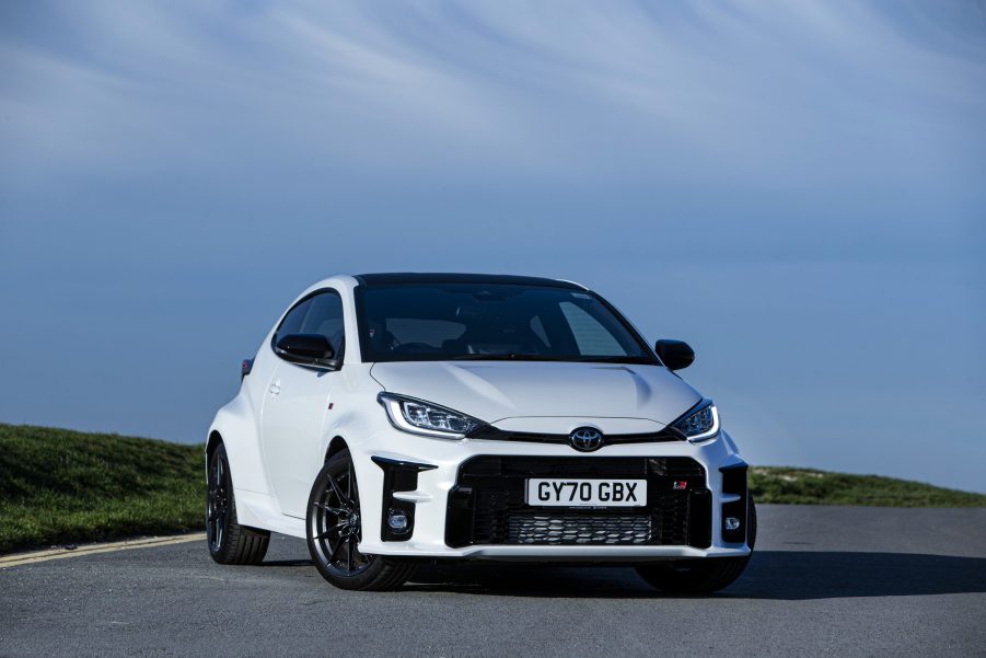 A white 2021 Toyota GR Yaris shot from the front 3/4 on an open road