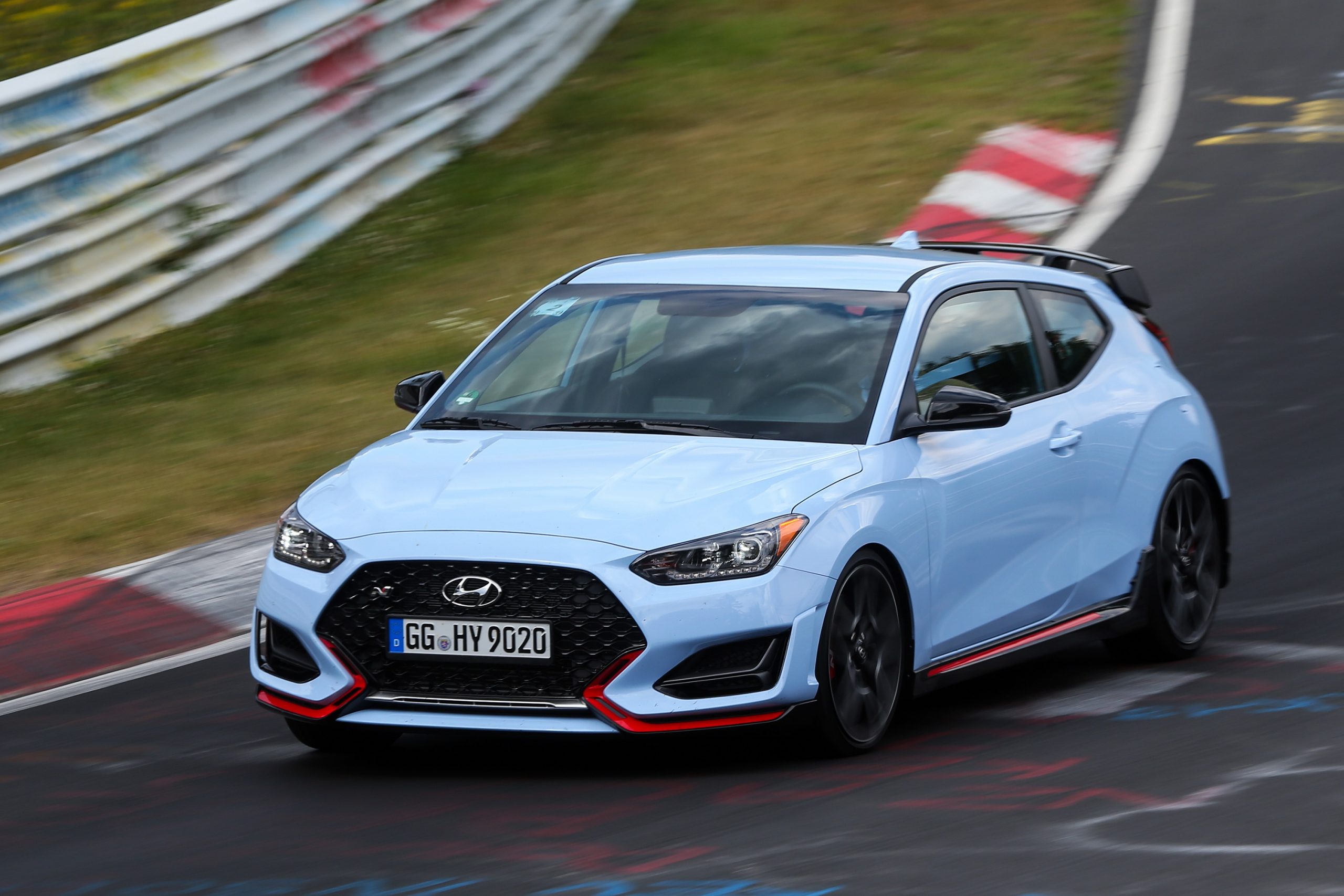 A pale blue Hyundai Veloster N lapping the Nurburgring shot from the front 3/4