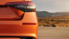 The rear of an orange 2022 Honda Civic Si