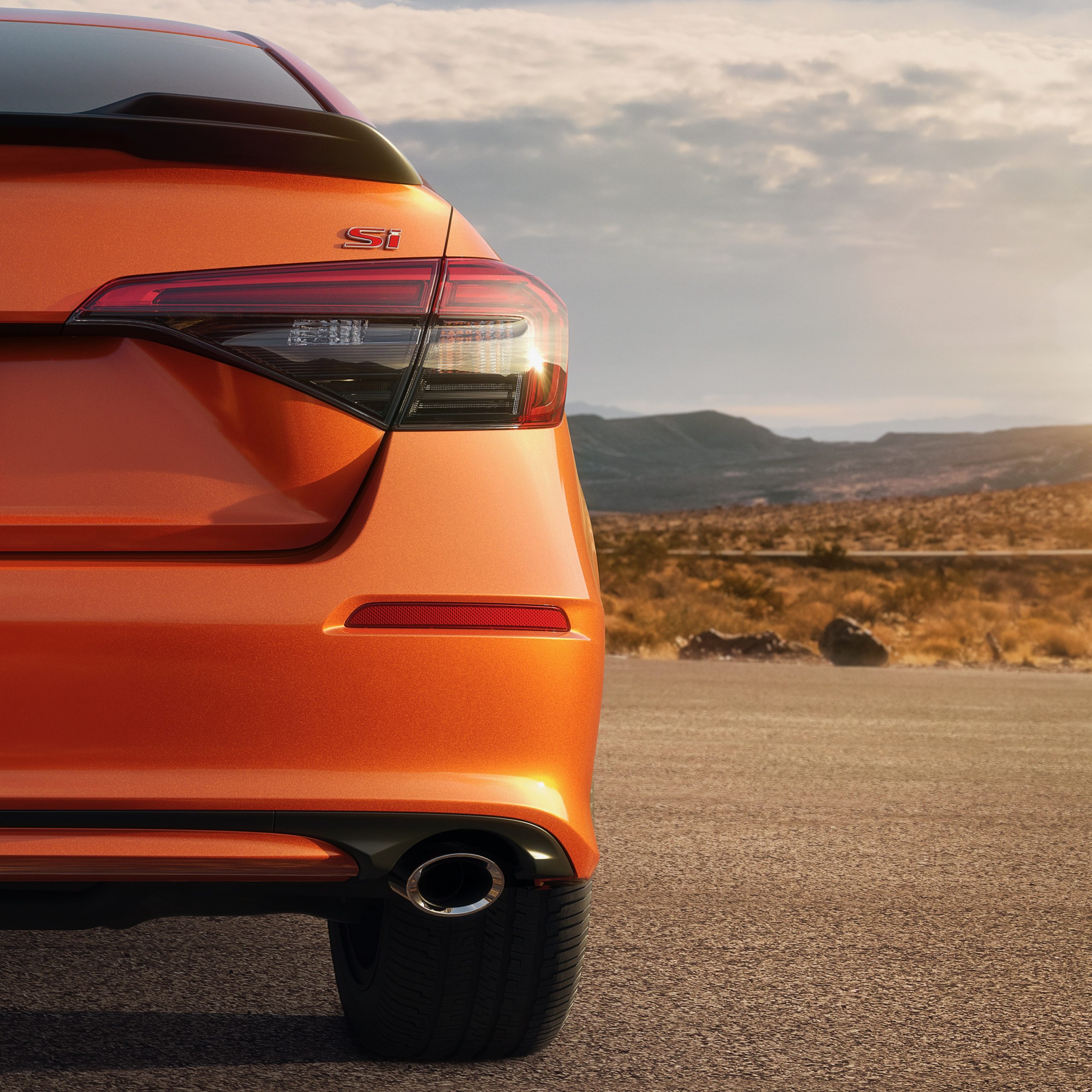 The rear of an orange 2022 Honda Civic Si