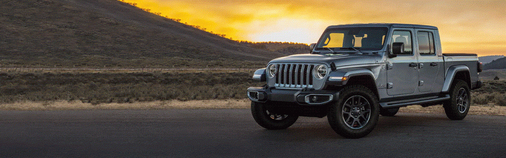 A gray 2022 Jeep Gladiator against a sunset.