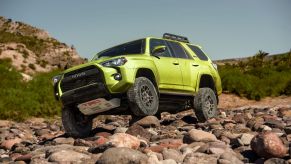 2022 Toyota 4Runner TRD Pro in Lime paint color option driving off-road on rocks